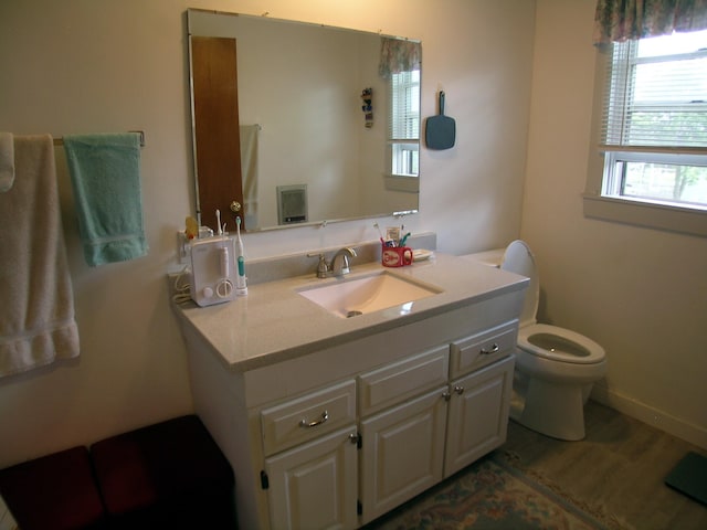 half bathroom featuring toilet and vanity