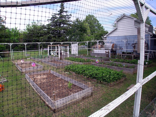 view of grassy yard with a garden