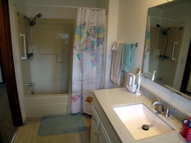 full bath featuring shower / tub combo with curtain, vanity, and wood finished floors