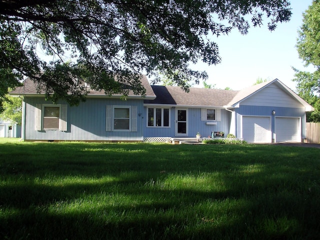 ranch-style house with a garage and a front yard