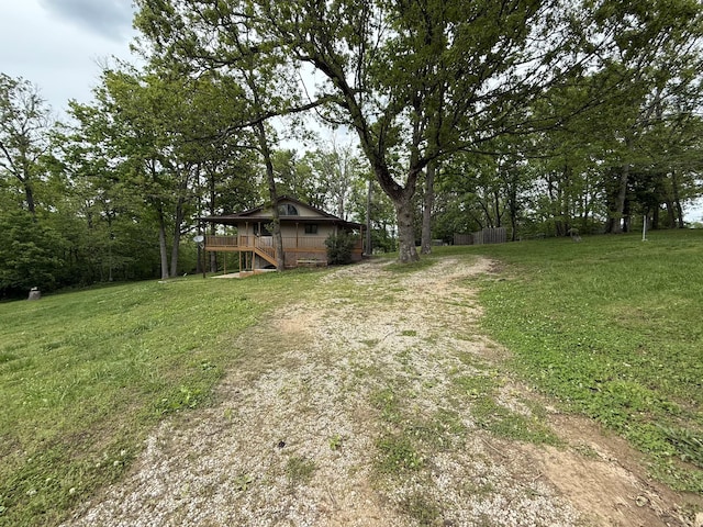 16709 Honeysuckle Hill Rd, Eminence, MO 65466 - view of green lawn featuring stairs, a wooden deck, and dirt driveway