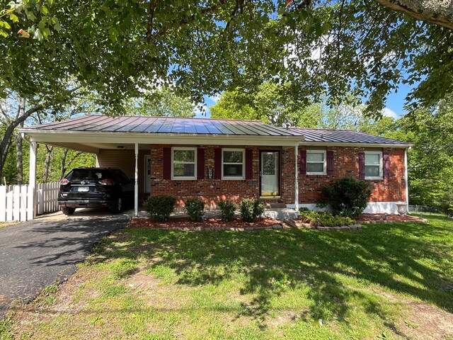 105 N Harms St, West Plains, MO 65775 - single story home featuring asphalt driveway, a carport, brick siding, and metal roof