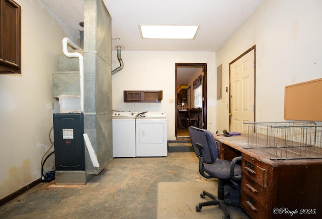 washroom featuring washer and clothes dryer and cabinet space