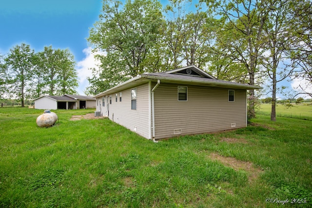 view of side of property with a lawn