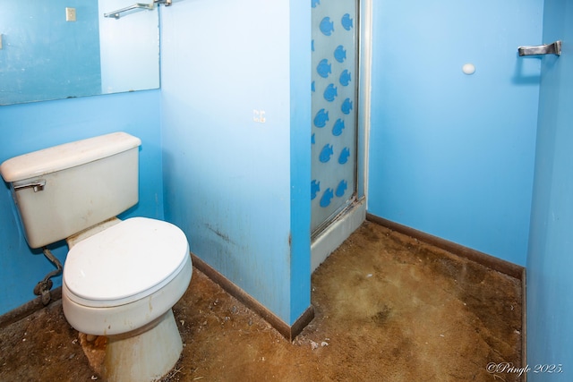 bathroom featuring baseboards, concrete floors, a stall shower, and toilet