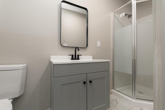 bathroom featuring toilet, marble look tiles, a shower stall, and vanity