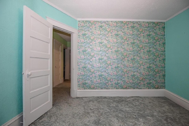 unfurnished room with crown molding, carpet flooring, wallpapered walls, and baseboards