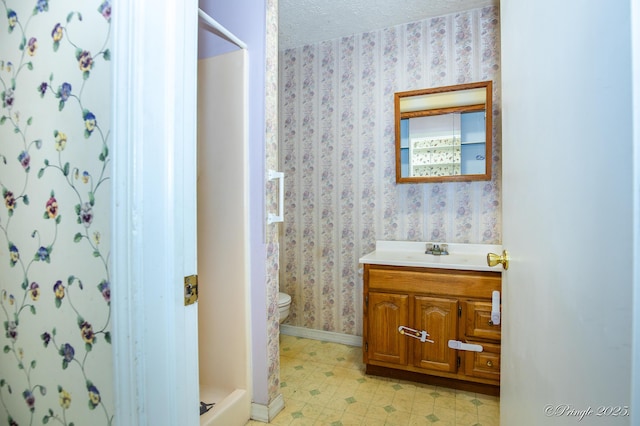 full bath with toilet, wallpapered walls, baseboards, vanity, and tile patterned floors