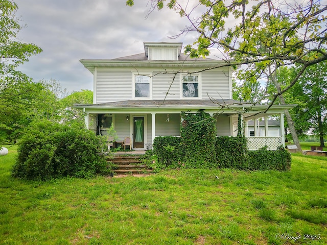 american foursquare style home featuring covered porch and a front lawn