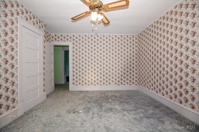 unfurnished bedroom featuring wallpapered walls, carpet, crown molding, and ceiling fan