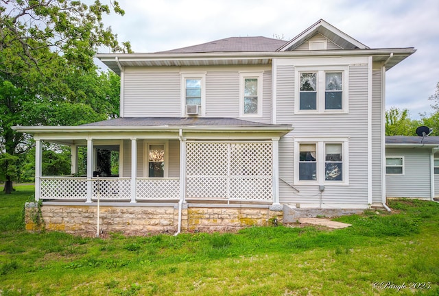 view of front of property featuring covered porch, a front lawn, and cooling unit