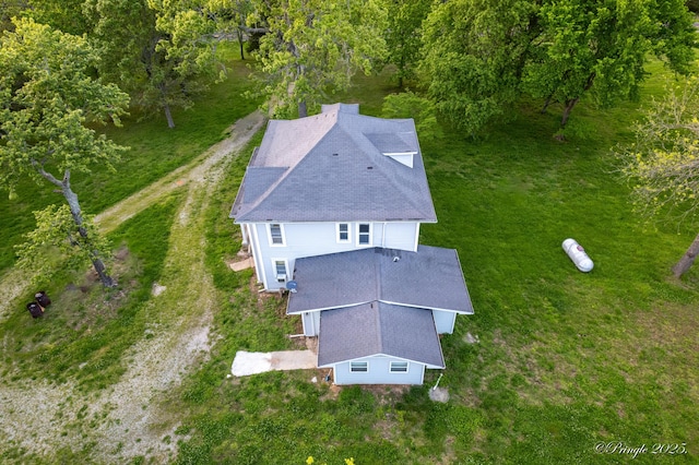 aerial view of property and surrounding area featuring a forest