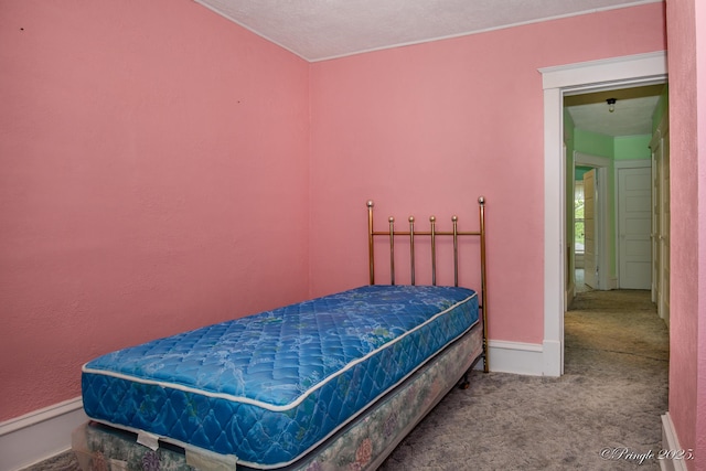 carpeted bedroom featuring baseboards