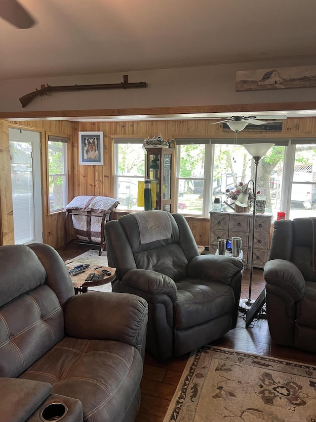 living room featuring hardwood / wood-style flooring and wooden walls