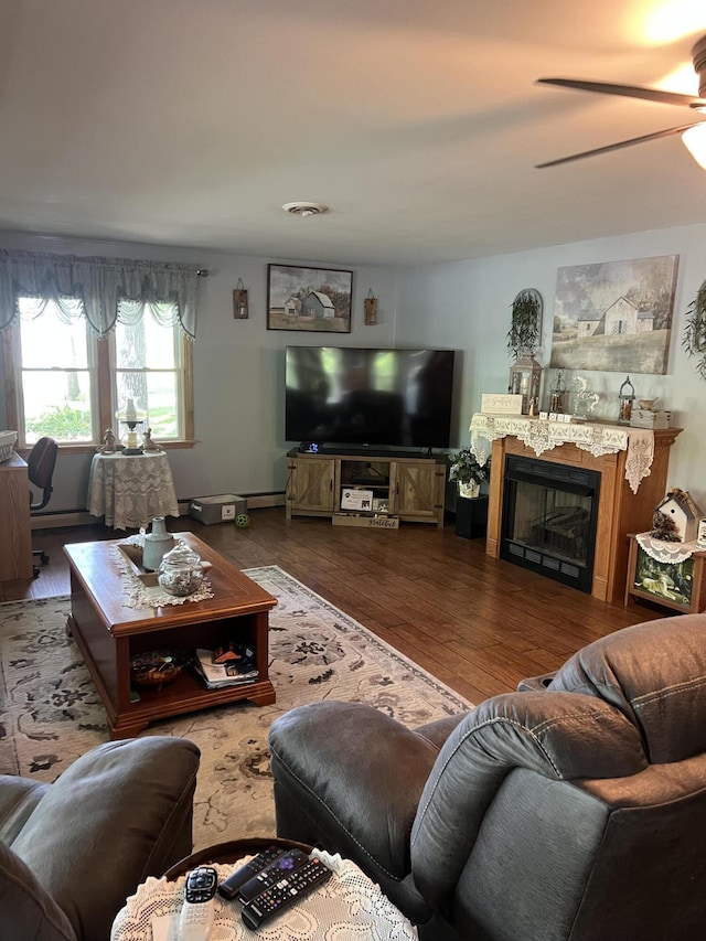 living room with ceiling fan, wood finished floors, and a fireplace