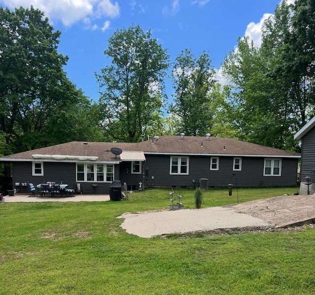 back of property featuring central AC unit, a patio, and a lawn