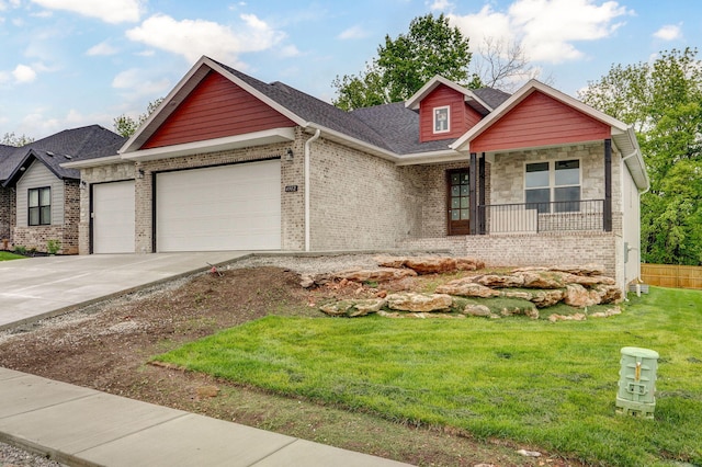 view of front of house featuring a garage, brick siding, a front lawn, driveway, and covered porch