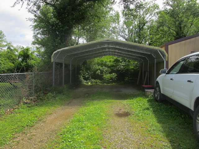 313 Washington St, Mountain View, MO 65548 - view of vehicle parking with fence, a detached carport, and dirt driveway
