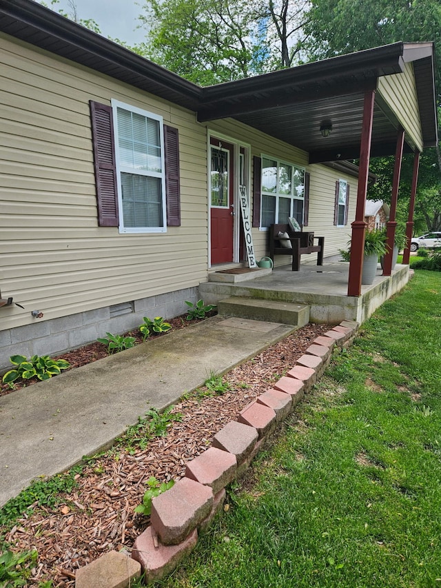313 Washington St, Mountain View, MO 65548 - view of exterior entry featuring a yard, crawl space, and covered porch