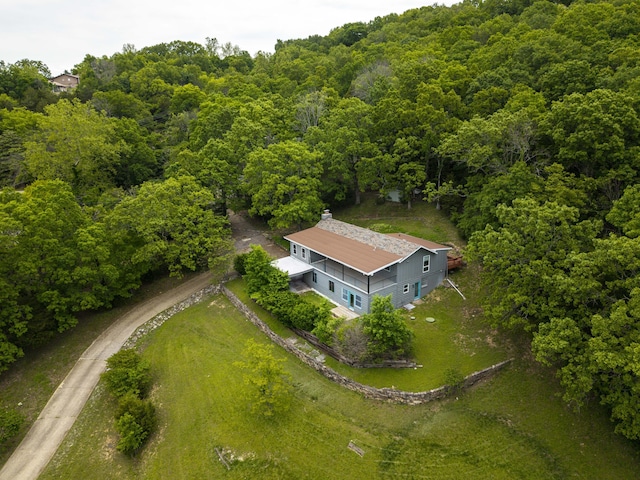 view from above of property featuring a heavily wooded area