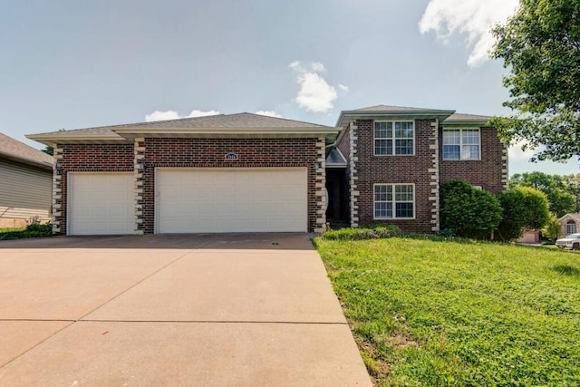 view of front of home with a front yard, brick siding, a garage, and driveway