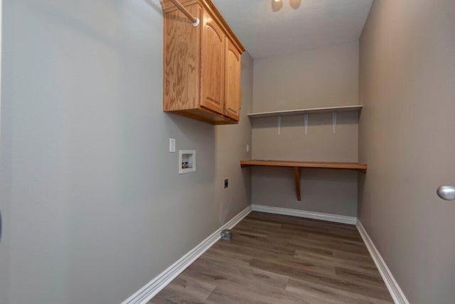 clothes washing area with washer hookup, hookup for an electric dryer, wood finished floors, cabinet space, and baseboards