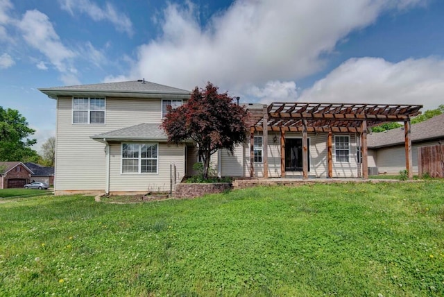 rear view of property featuring a pergola and a lawn