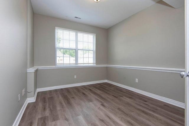 empty room with wood finished floors and baseboards