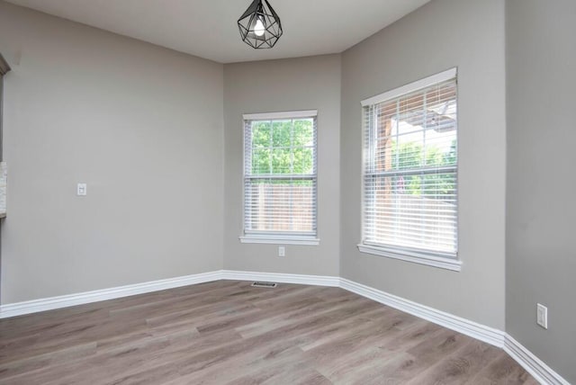 unfurnished room featuring wood finished floors and baseboards