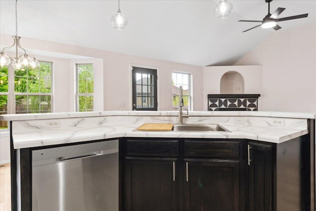 kitchen featuring stainless steel dishwasher, vaulted ceiling, open floor plan, a sink, and a ceiling fan