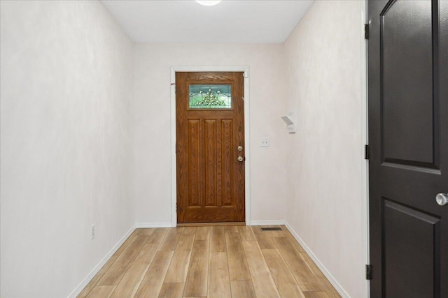 entryway with light wood-style flooring and baseboards