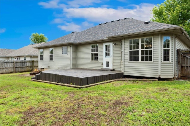 rear view of house featuring a wooden deck and a shingled roof