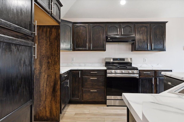 kitchen featuring gas stove, ventilation hood, dark brown cabinets, light stone countertops, and light wood-type flooring