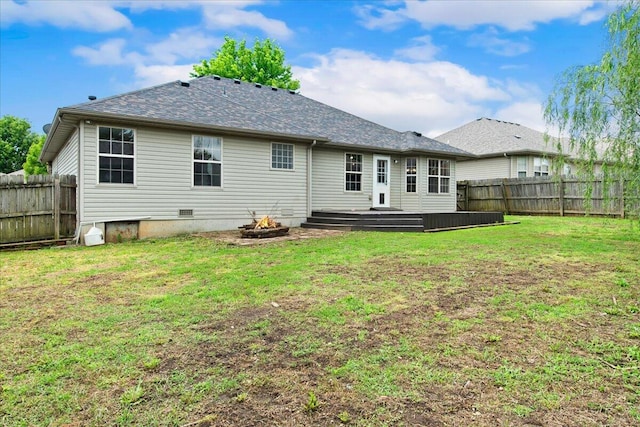 back of property with a deck and a shingled roof
