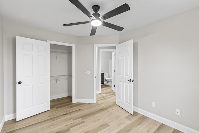 unfurnished bedroom with light wood-style flooring, baseboards, a closet, and ceiling fan
