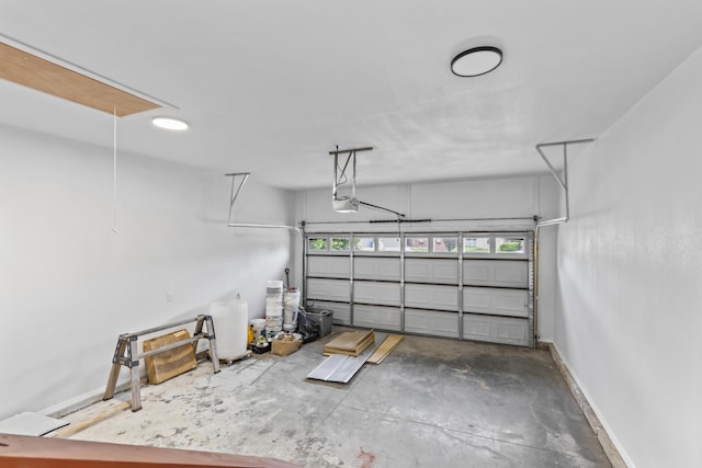 garage with a garage door opener and baseboards