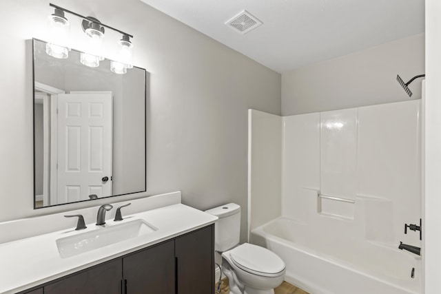 full bath featuring toilet, vanity, and shower / washtub combination
