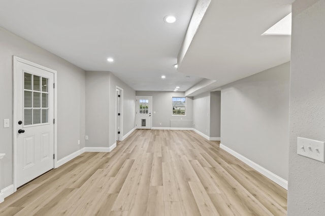 basement with light wood finished floors, recessed lighting, and baseboards
