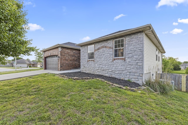 view of front of house with stone siding, a garage, and driveway