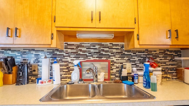 920 Oak St, Thayer, MO 65791 - kitchen featuring a sink, light countertops, and decorative backsplash