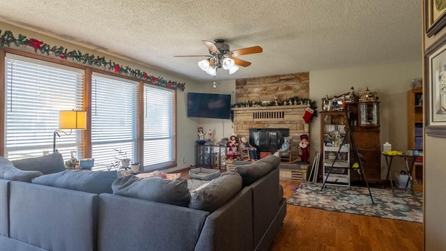 920 Oak St, Thayer, MO 65791 - living area with ceiling fan, wood finished floors, a textured ceiling, and a stone fireplace