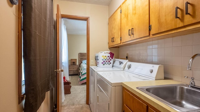 920 Oak St, Thayer, MO 65791 - laundry room with cabinet space, washer and dryer, light tile patterned flooring, a textured ceiling, and light colored carpet