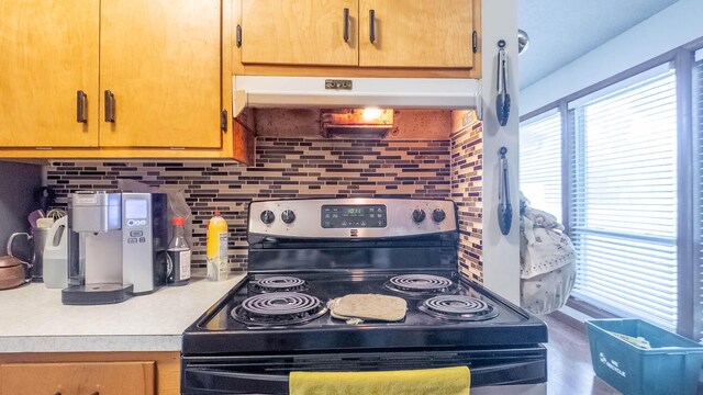 920 Oak St, Thayer, MO 65791 - kitchen with electric stove, under cabinet range hood, light countertops, and decorative backsplash
