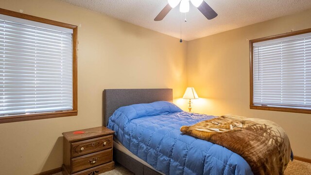 920 Oak St, Thayer, MO 65791 - bedroom with carpet floors, a textured ceiling, baseboards, and ceiling fan