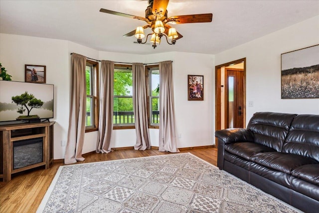 1215 E 515th Rd, Morrisville, MO 65710 - living area with a ceiling fan, wood finished floors, and baseboards