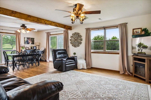 1215 E 515th Rd, Morrisville, MO 65710 - living room featuring a ceiling fan, plenty of natural light, wood finished floors, beam ceiling, and baseboards