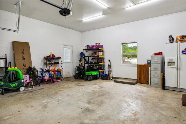 1215 E 515th Rd, Morrisville, MO 65710 - garage with white refrigerator with ice dispenser and a garage door opener