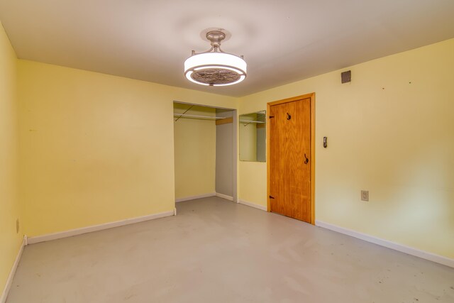 713 Taneycomo Rd, Branson, MO 65616 - unfurnished bedroom with a closet, concrete flooring, and baseboards