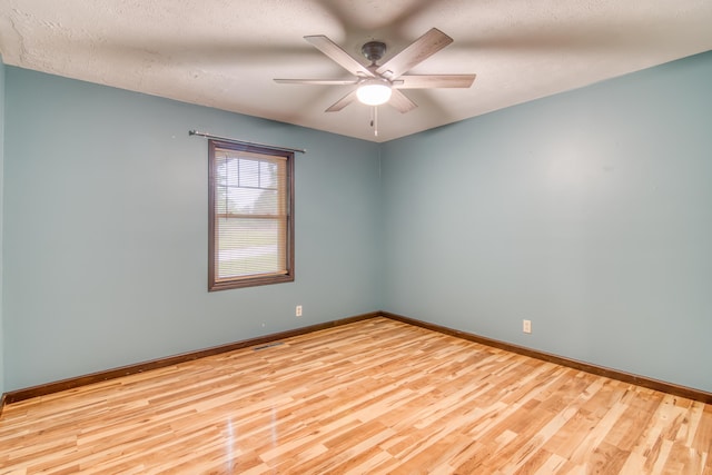 713 Taneycomo Rd, Branson, MO 65616 - spare room featuring wood finished floors, baseboards, ceiling fan, and a textured ceiling