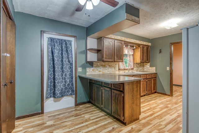 713 Taneycomo Rd, Branson, MO 65616 - kitchen with light wood-style flooring, a peninsula, open shelves, ceiling fan, and a textured ceiling